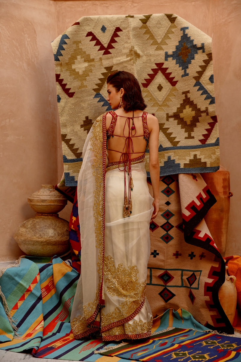 Fawn 'QUEEN' saree withh beetroot sleeveless tie-up blouse.