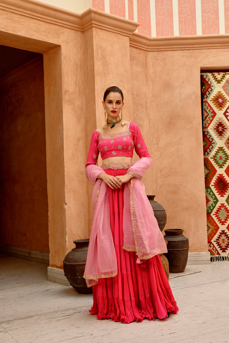 Hot pink tier lehenga with blouse and  dupatta.